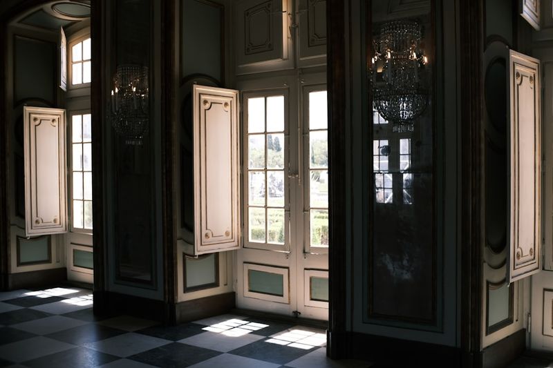 A room with a checkered floor and a chandelier